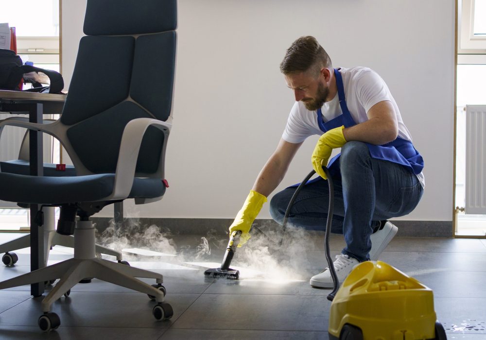 professional-cleaning-service-person-using-steam-cleaner-office